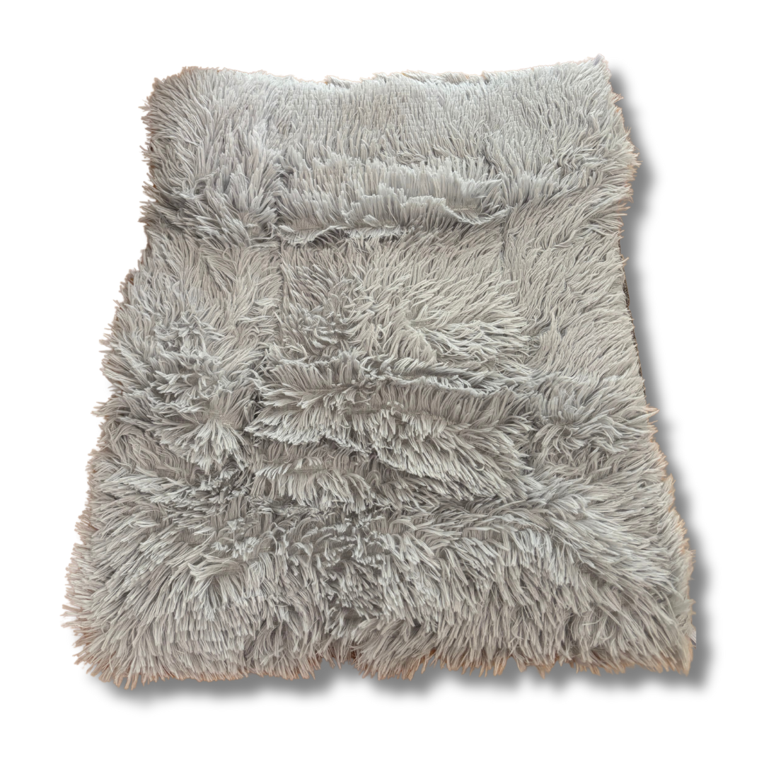Gray fluffy pet bed on a white background