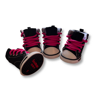 Black high-top sneakers with pink laces on a white background
