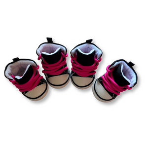 Four pairs of baby shoes with pink shoelaces on a white background