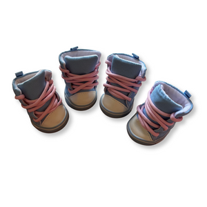 Pair of children's boots with pink laces on a white background