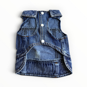 A blue denim pet vest with three white snap buttons, shown from the back on a white background.
