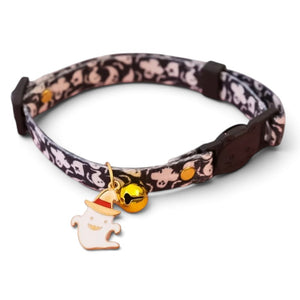 A patterned cat collar with a black and white ghost design, featuring a small gold bell and a ghost charm wearing a gold and red hat.