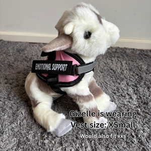 Stuffed animal wearing an 'Emotional Support' vest on a gray carpet