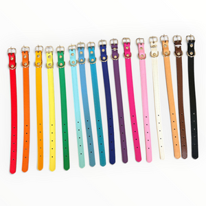 A row of 16 different coloured leather dog collar with silver metal hardware and white stitching, shown against a plain white background.
