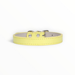 A light yellow leather collar with silver-tone metal hardware and a light beige interior lining, shown against a plain white background.