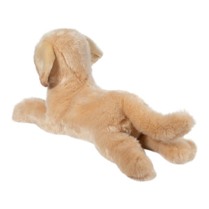 Plush toy dog lying on a white background