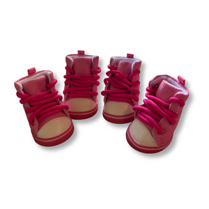 Set of red baby shoes with pink laces on a white background