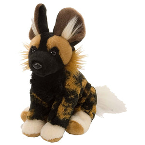 Plush toy of a wild dog with black, brown, and white fur on a white background