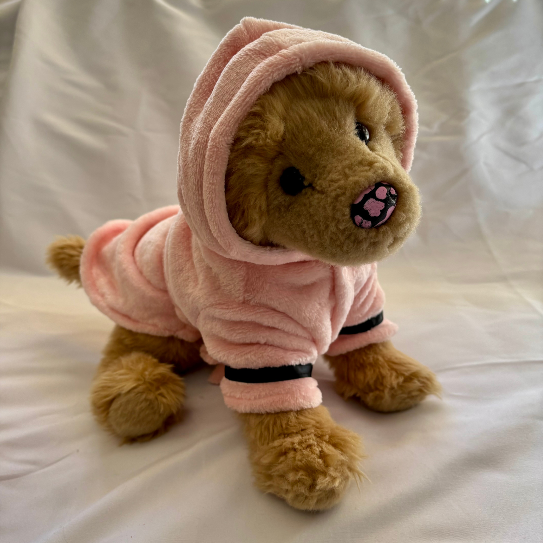 Golden retriever plush dog wearing pink bathrobe