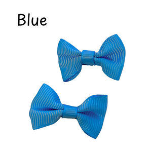 Two blue bow-shaped hair accessories on a white background with the word 'Blue' above them.