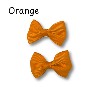 Two orange hair bows on a white background with 'Orange' text above.