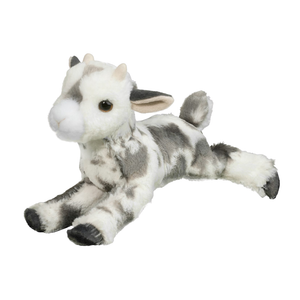 Plush toy goat lying on a white background