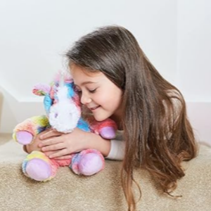 Girl hugging a Rainbow Unicorn Warmies Heatbag Weighted Plushie
