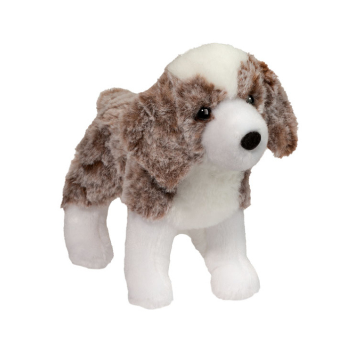 A plush toy dog with brown and white fur, standing against a plain white background.