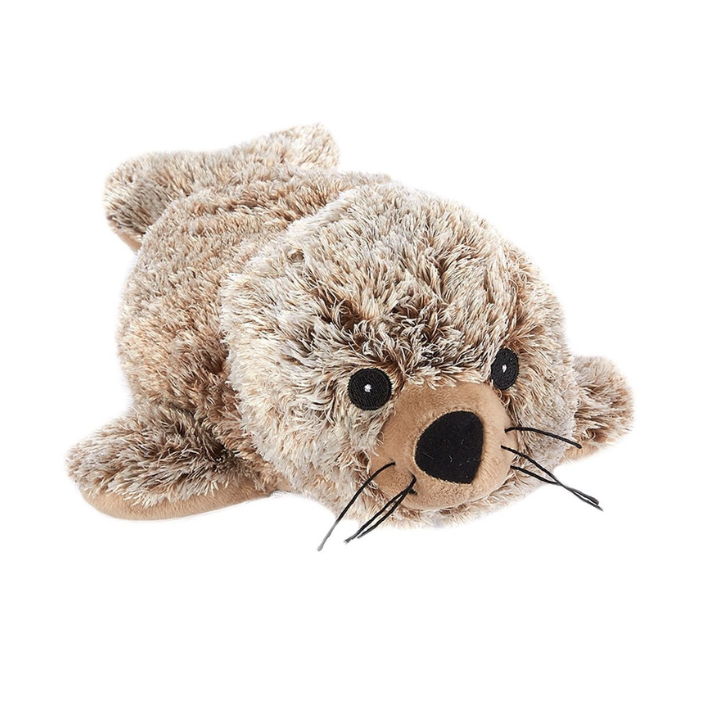 A plush toy seal lying down, made of shaggy brown and beige faux fur with a tan snout, black eyes, and black whiskers, photographed on a solid white background.