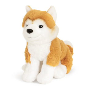 Plush toy dog with orange and white fur on a white background