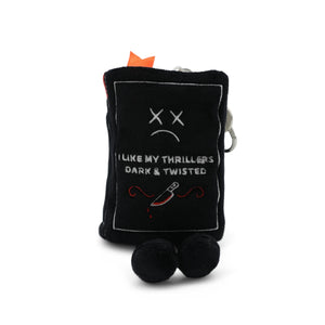 Black plush toy with a sad face and text on a white background