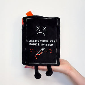 Black plush toy with text and design on a white background