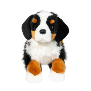 Plush toy dog with black, white, and brown color pattern on a white background