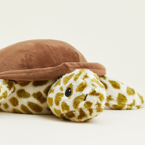 Plush toy giraffe with a brown hat on a light background