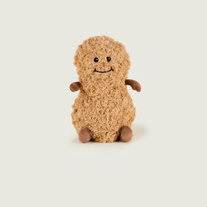 Brown teddy bear plush toy on a light beige background