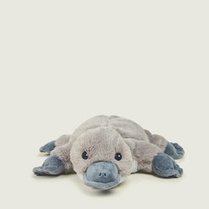 A plush stuffed animal of a platyptodont (platyptodon) toy, featuring a soft gray body and blue-gray snout, feet, and hands, lying on its side against a light cream background.