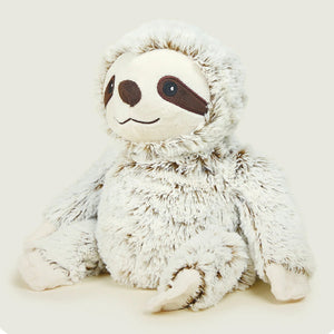Plush toy sloth on a light beige background