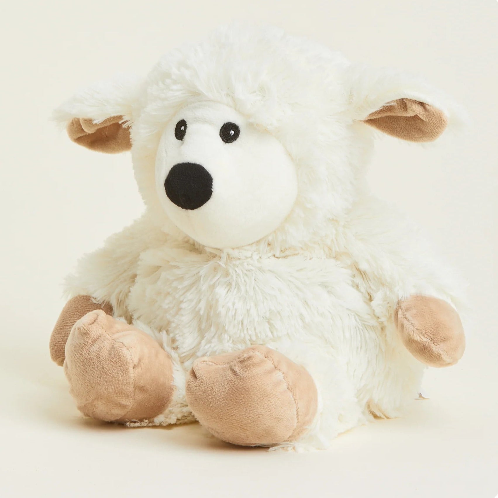 White plush lamb toy with brown feet on a white background