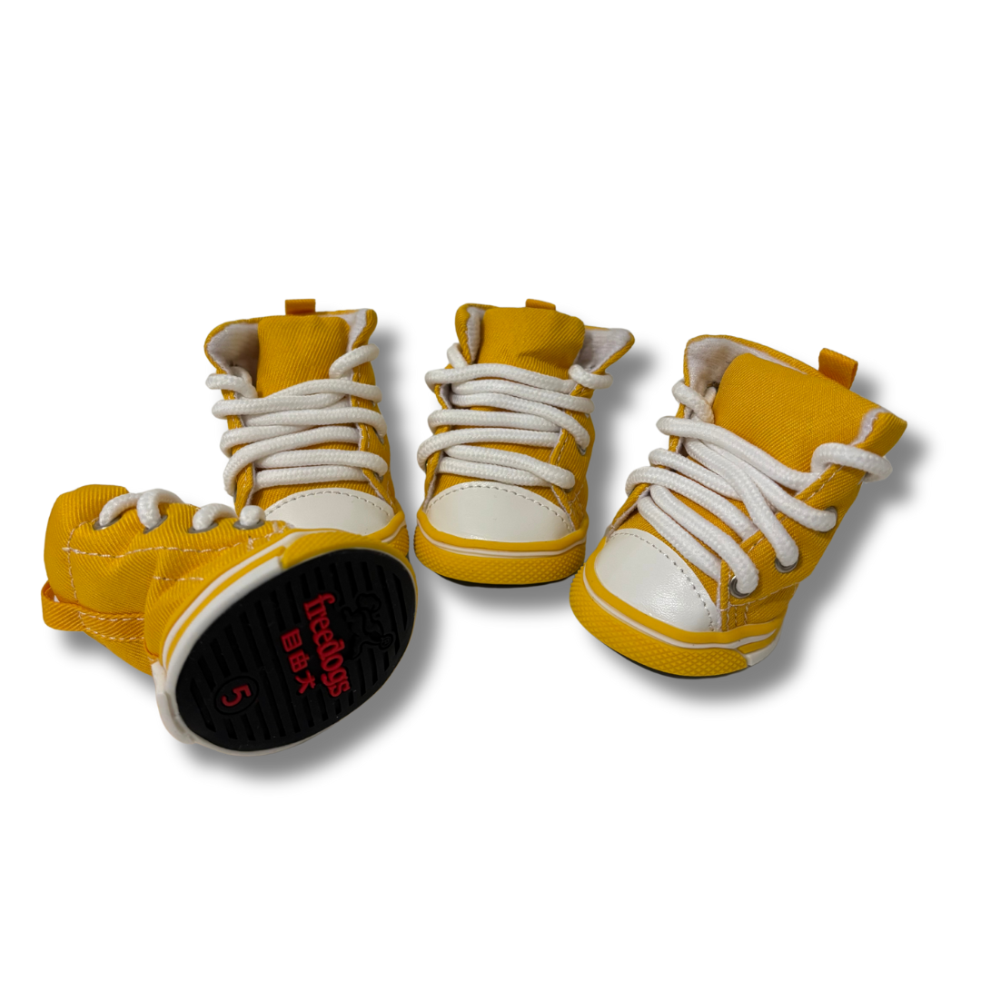 Yellow high-top sneakers with white laces on a white background