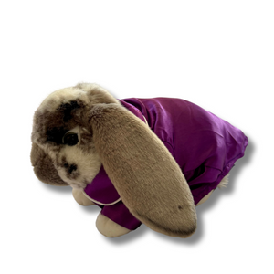 A plush rabbit wearing purple pyjamas