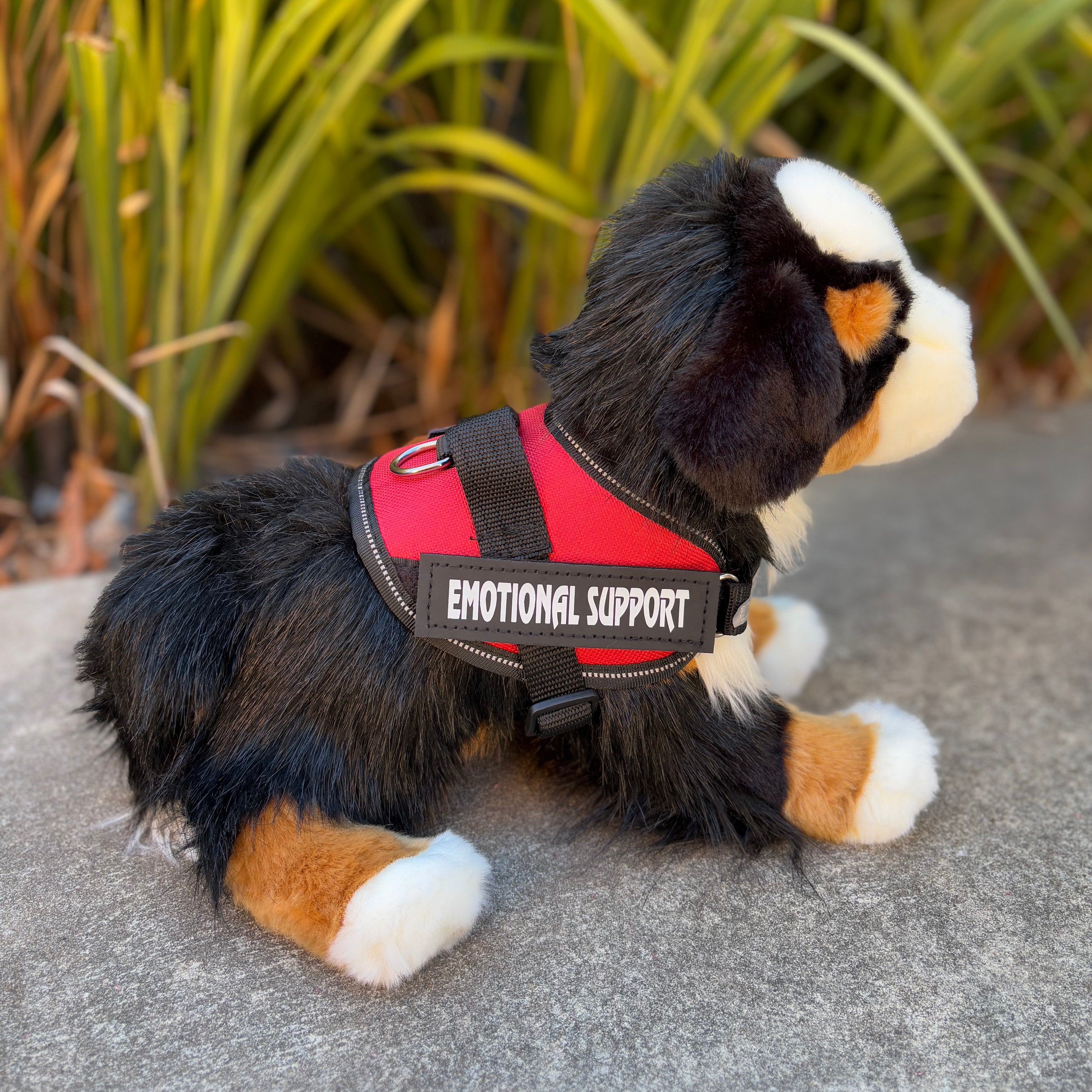 The Bernese Mountain dog emotional support stuffed animal side view showing red essa gear
