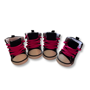 Four pairs of black and pink high-top sneakers on a white background