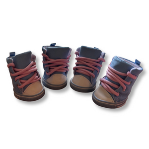 Four pairs of children's boots with pink laces on a white background