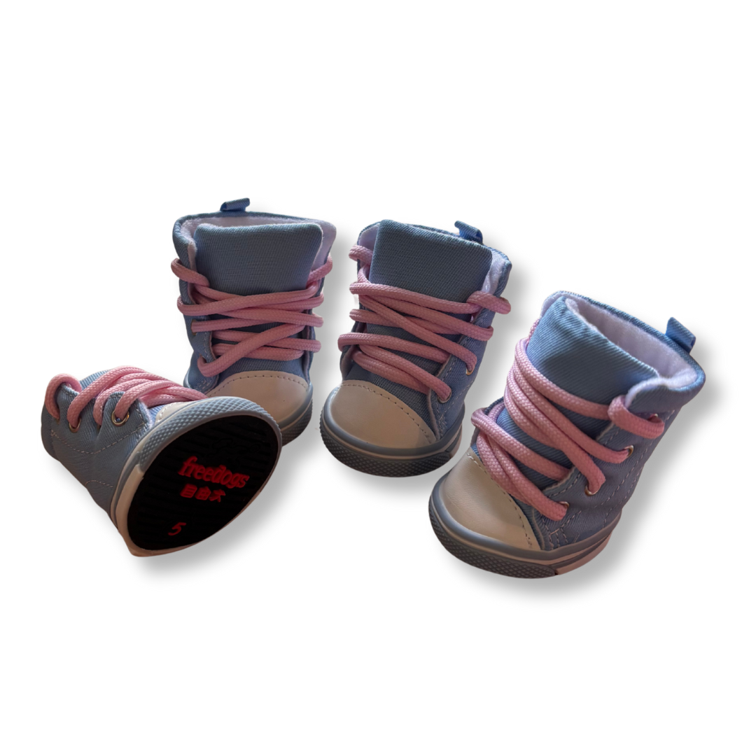 Pair of children's boots with pink laces on a white background