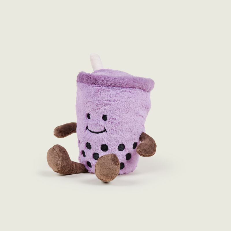Plush toy resembling a purple bubble tea cup with brown bases on a light beige background