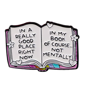 Open book with text 'In a really good place right now, in my book of course... not mentally' on a white background