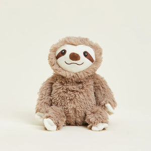 Plush toy sloth on a light beige background