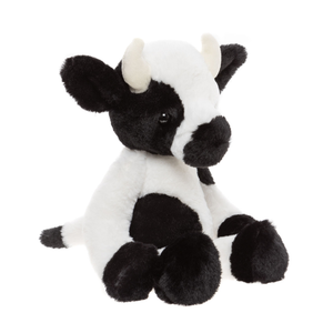 Plush cow toy with black and white pattern on a white background