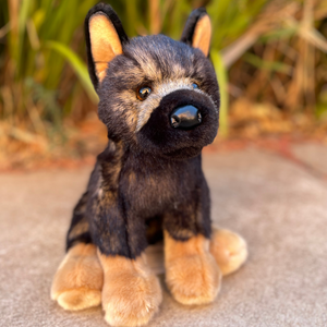 Chief German Shepherd by Douglas Dog siting in front of green bushes