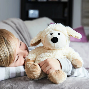 Child hugging Warmies Sheep Heatbag Plushie