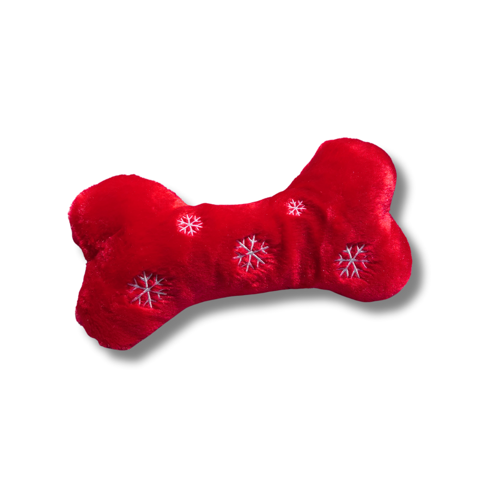 Red bone-shaped dog toy with snowflake patterns on a white background