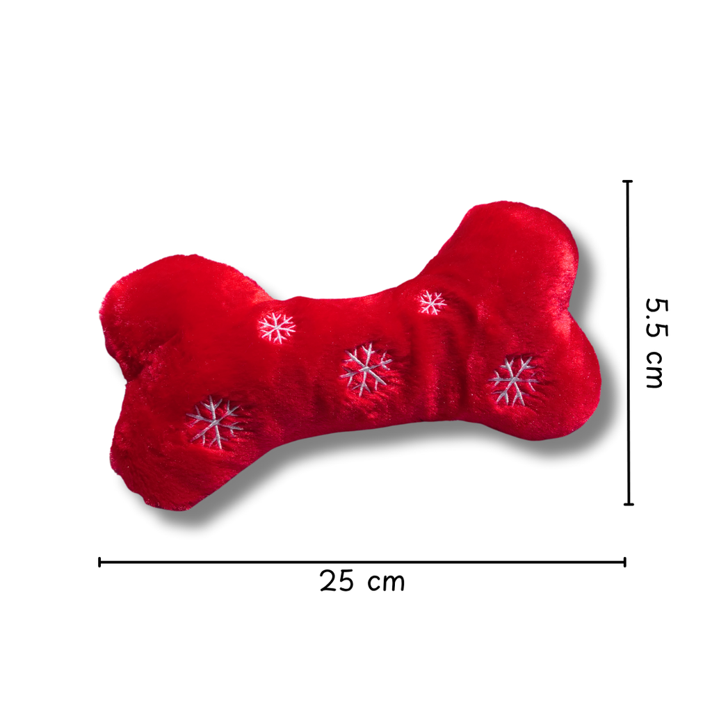 Red bone-shaped pillow with snowflake patterns and measurements on a white background