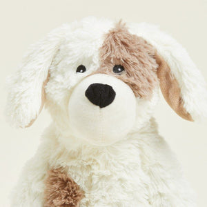 Plush dog toy with a white body, brown ears, and black nose on a light beige background