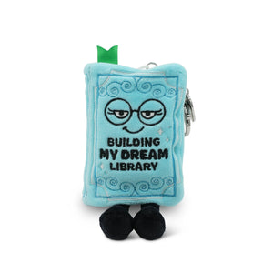 Plush toy book character with a face and text 'Building My Dream Library' on a white background