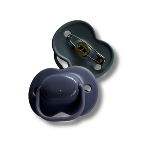 Two pacifiers, one dark gray and one navy blue, on a white background.