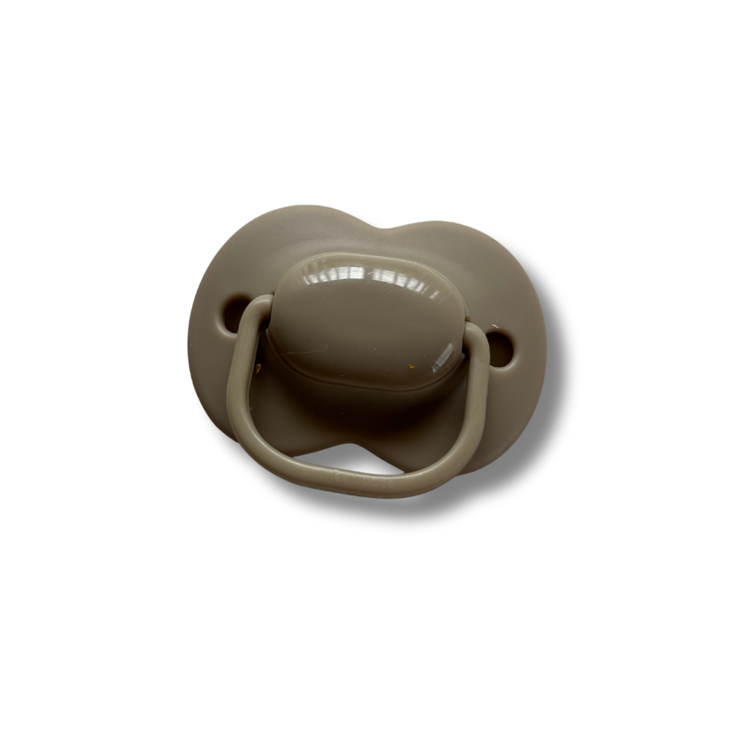 Brown pacifier on a white background