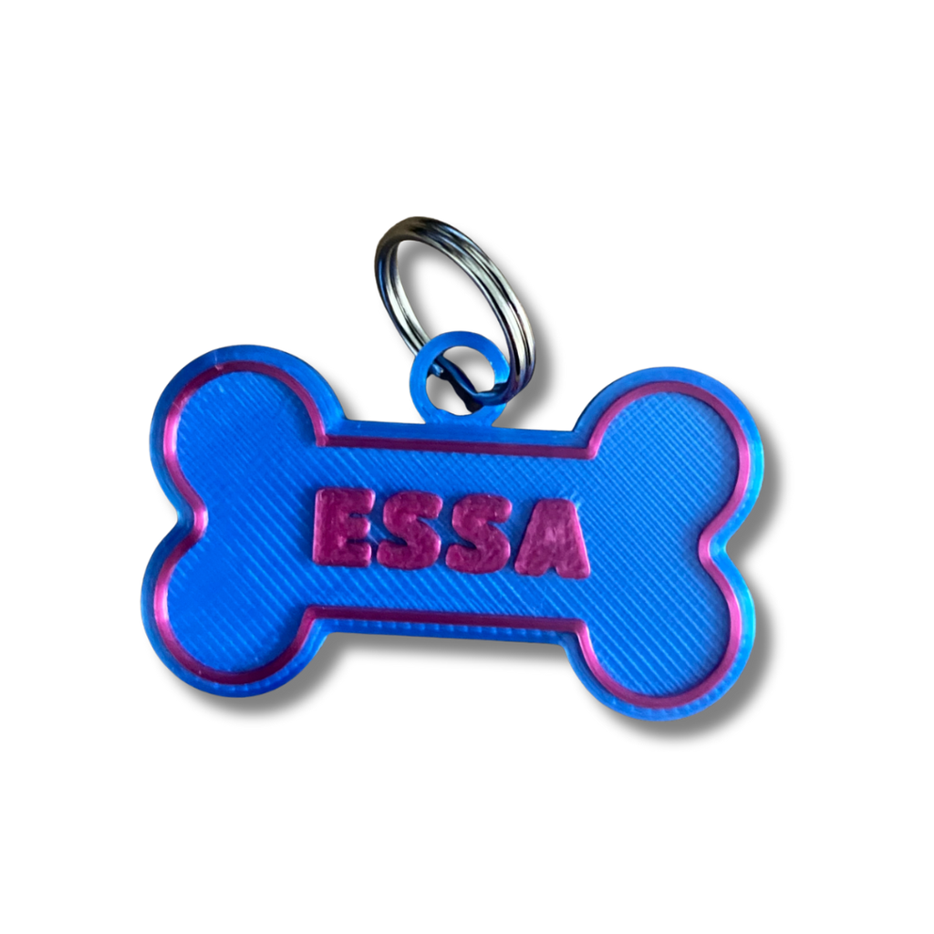 Blue bone-shaped pet tag with 'ESSA' engraved on a white background