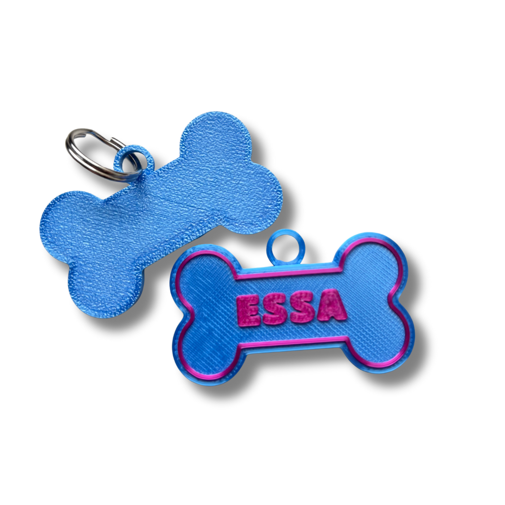 Blue bone-shaped pet tag with 'ESSA' embroidered on a white background