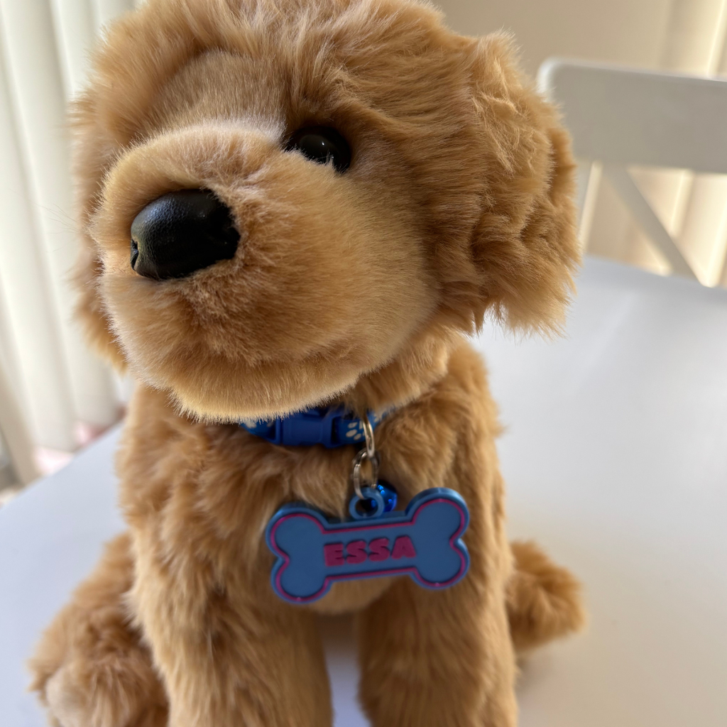 Stuffed dog toy with a blue bone-shaped tag on a white surface