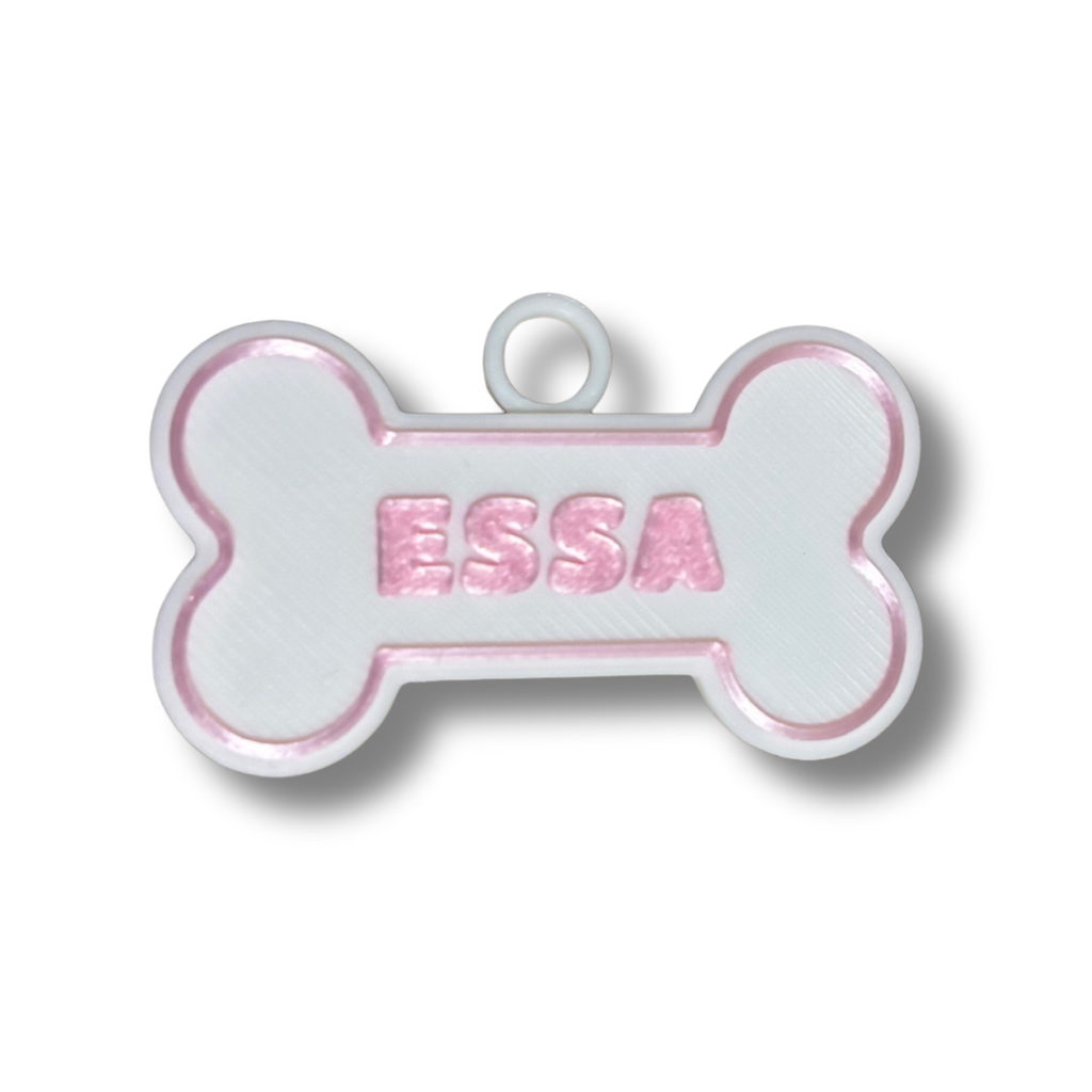 Bone-shaped pet tag with 'ESSA' engraved on a white background